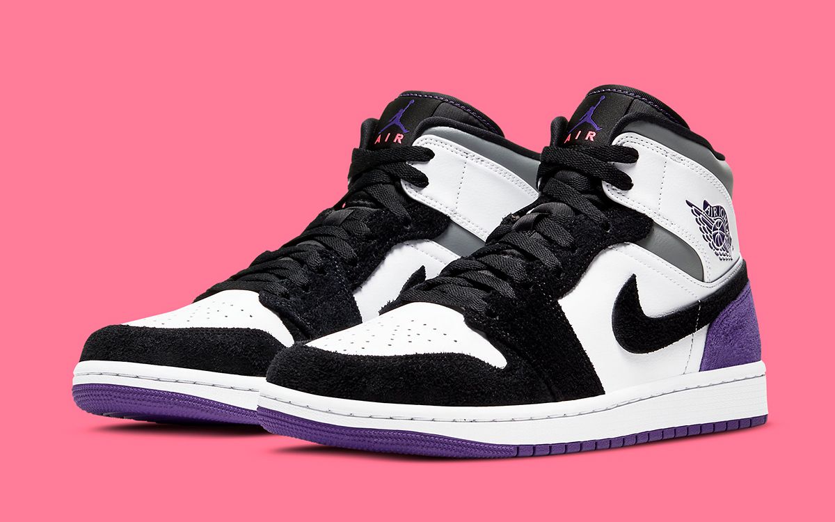 black and white jordans with purple logo