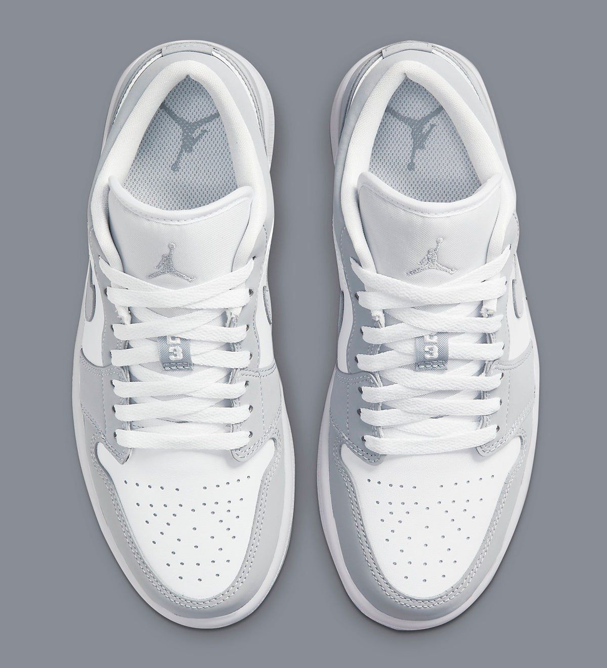 grey and white low top jordans
